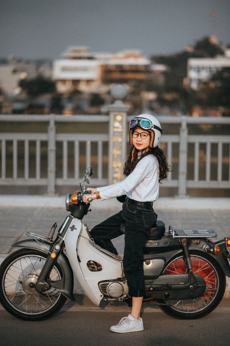 A rider in a helmet sitting on her motorcycle