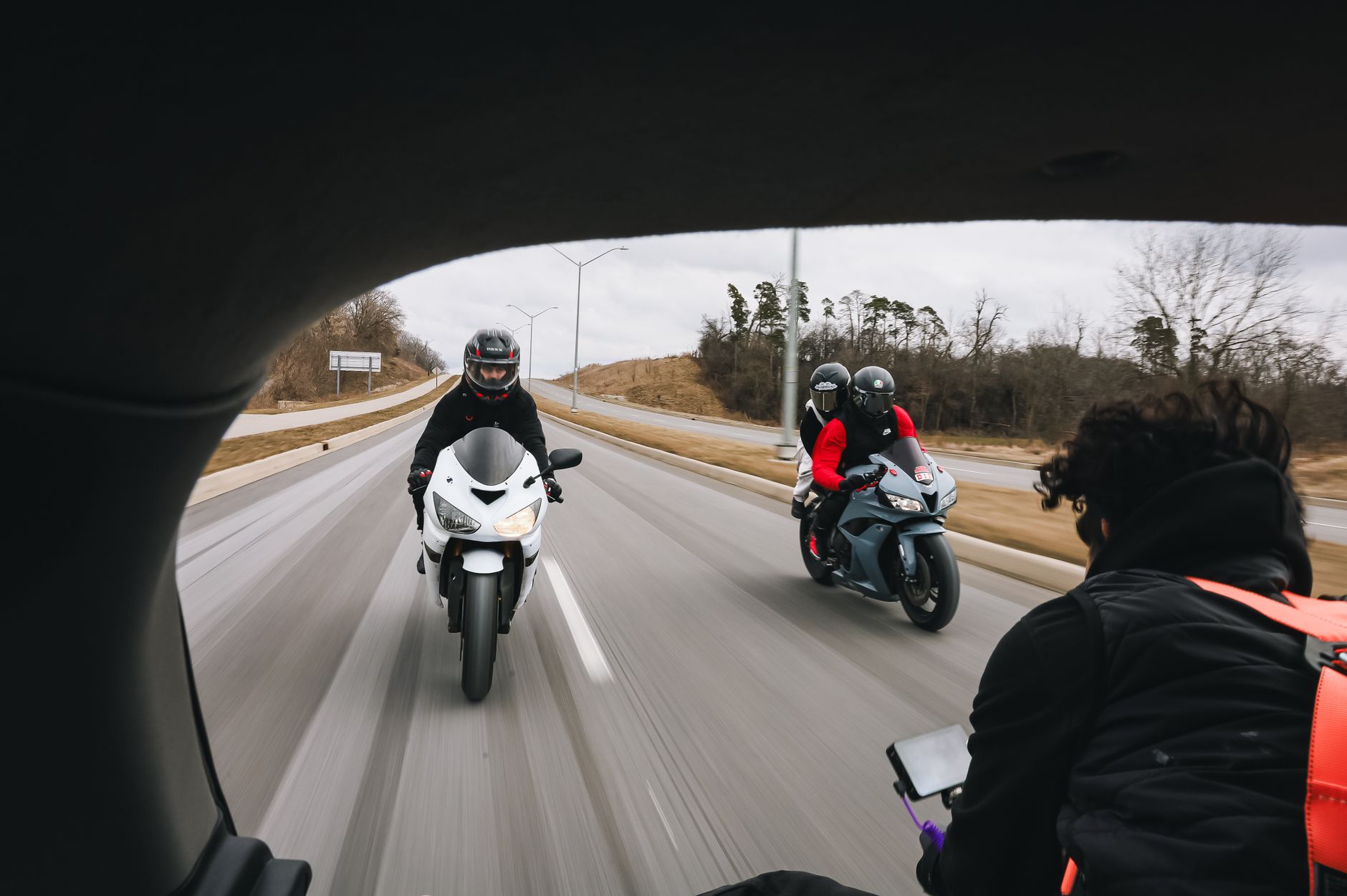 Motorcyclists riding together along an open highway