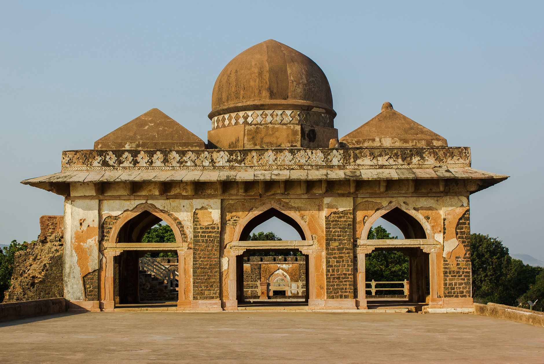 Arched historic stone architecture under a blue sky