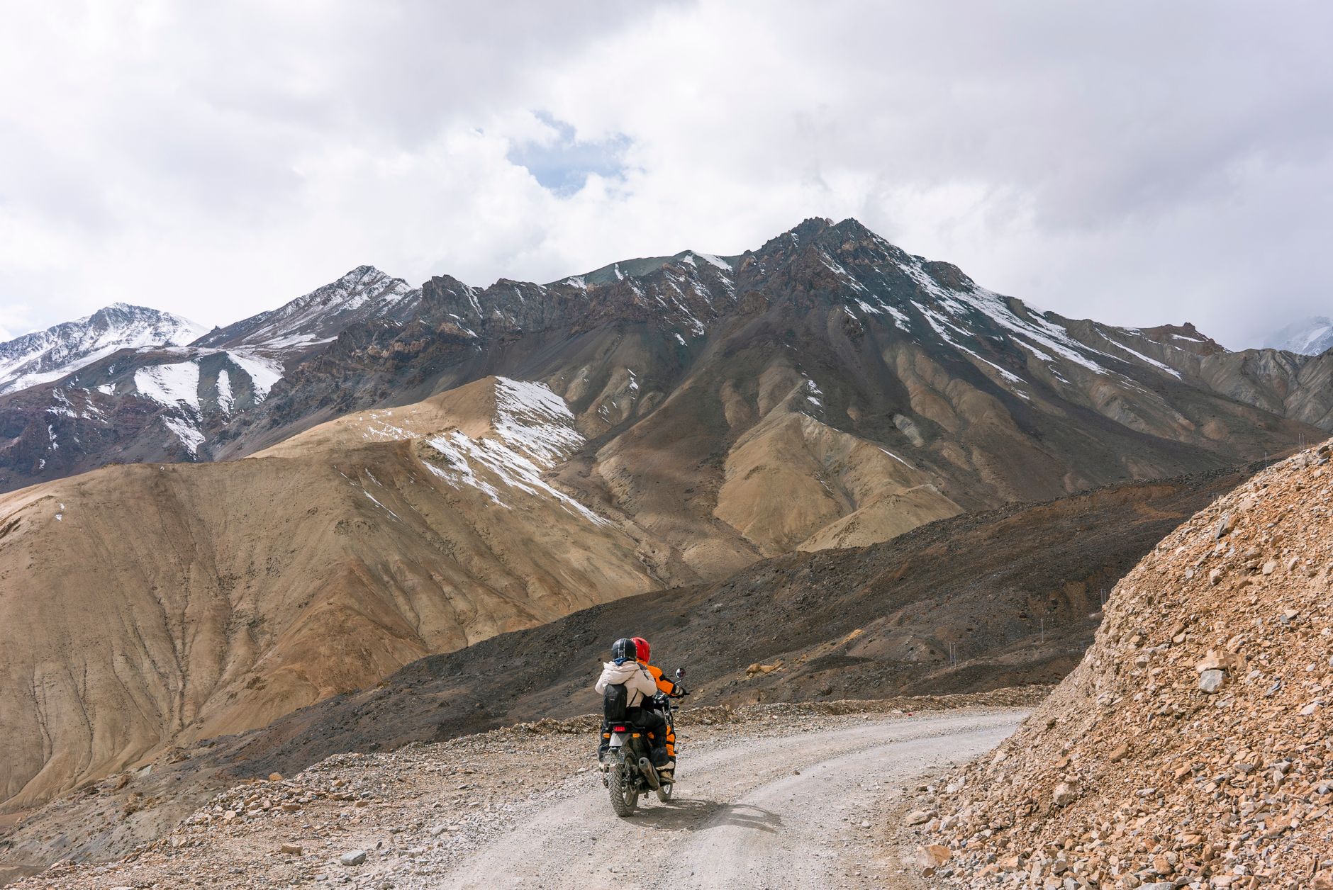 Two riders on a winding mountain road